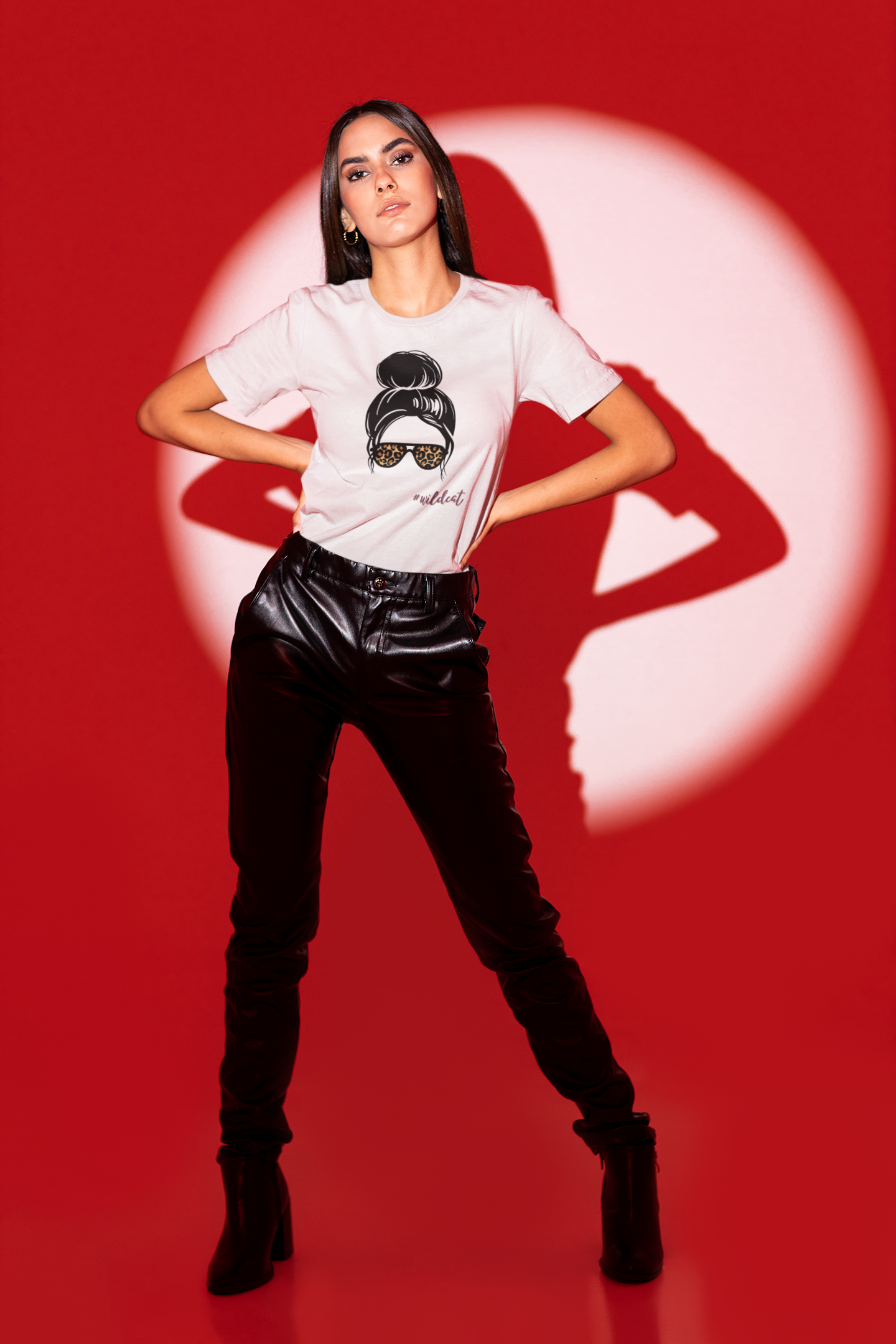 Person wearing a white t-shirt with a graphic design on a red background