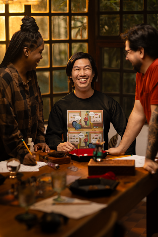 Three people are gathered around a table with a laptop, celebrating and smiling. The room has a warm, cozy ambiance with low lighting and a comfortable setting.