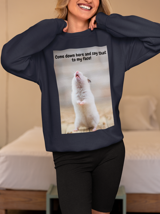 Person wearing a navy blue sweatshirt with a graphic of a mouse and text, standing in a bedroom.