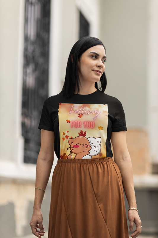 Woman wearing a black t-shirt with a colorful graphic design outdoors.