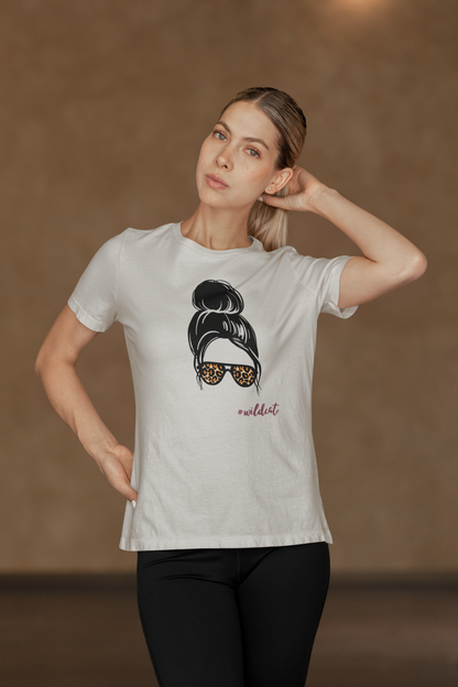 Woman wearing a white t-shirt with a graphic design on a brown background